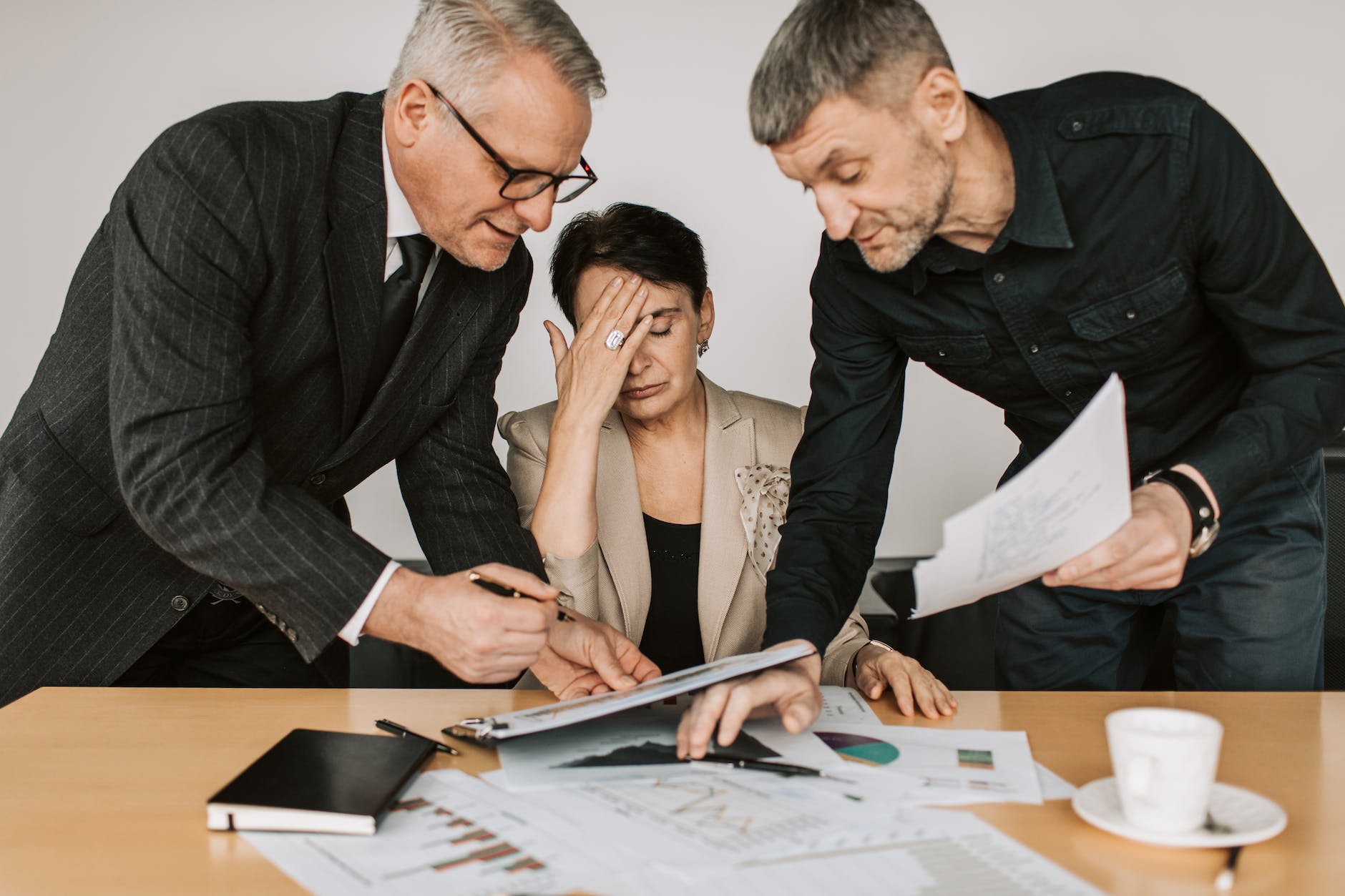 stressed woman between her colleagues