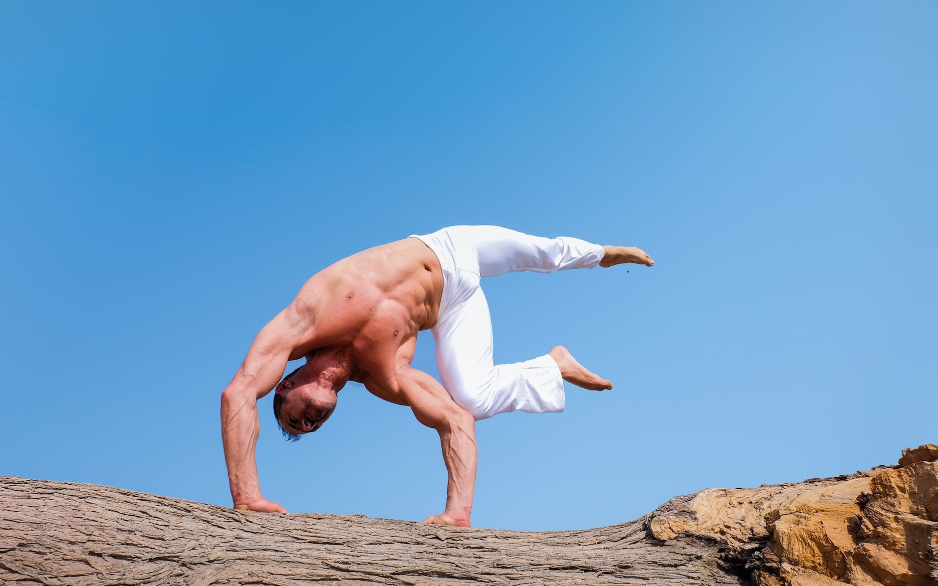 man wearing white pants under blue sky